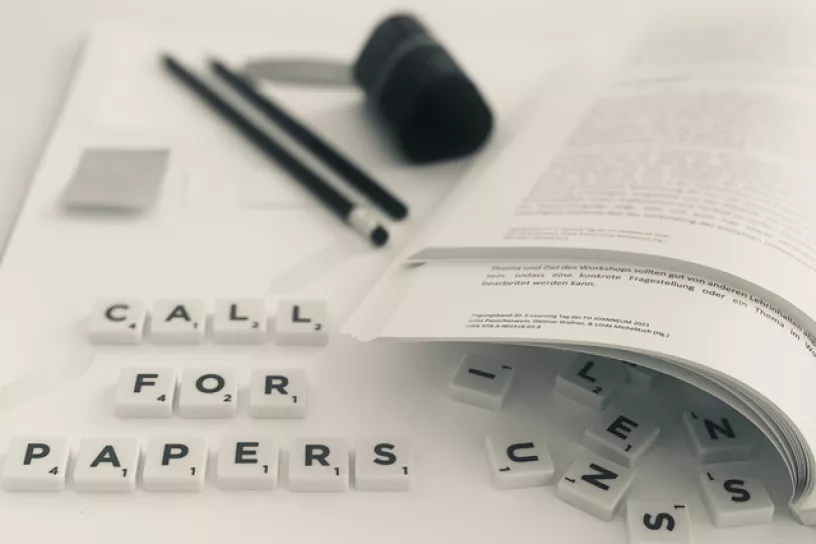 Scrabble Bausteine, Bleistift, Spitzer und eine Broschüre
