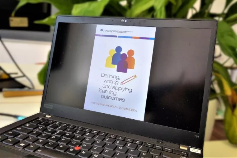 Laptop, darauf das Titelbild des Handbuchs