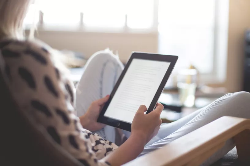 Person liest auf E-Reader.